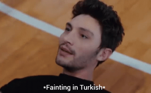 A Man Laying On The Floor With The Words Fainting In Turkish Above Him GIF