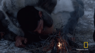A Man Laying On The Ground With A National Geographic Logo In The Background GIF
