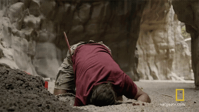 A Man Laying On The Ground With A National Geographic Logo On The Bottom GIF