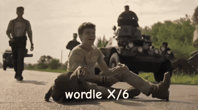 A Man Laying On The Ground With The Words Wordle X / 6 Written On The Bottom GIF