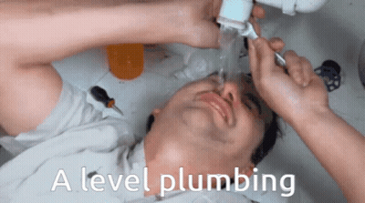 A Man Laying Under A Sink With The Words " A Level Plumbing " On The Bottom GIF