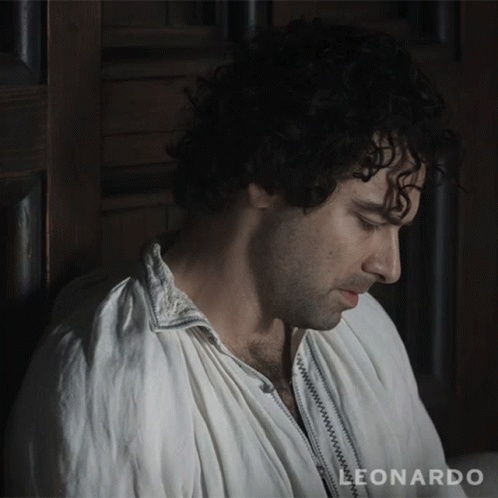 A Man Leaning Against A Wall With The Word Leonardo On The Bottom Right GIF