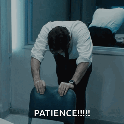 A Man Leaning On A Chair With The Words Patience Written On The Bottom GIF