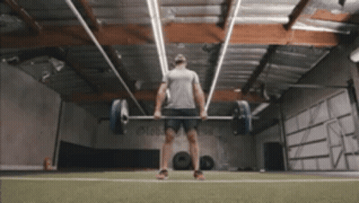 A Man Lifting A Barbell In A Gym GIF