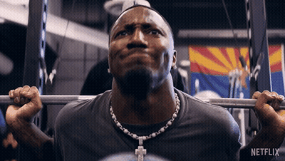 A Man Lifting A Barbell In A Gym With Netflix Written On The Bottom GIF