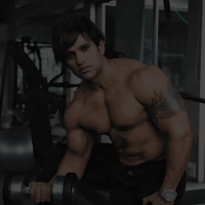 A Man Lifting A Dumbbell In A Gym With The Words Where Sweat Turns Into Strength GIF