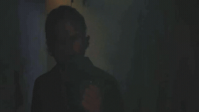 A Man Lighting A Cigarette With The Words " You Still " In The Background GIF