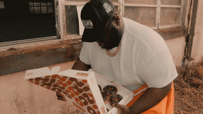 A Man Looking At A Dunkin Donuts Box GIF