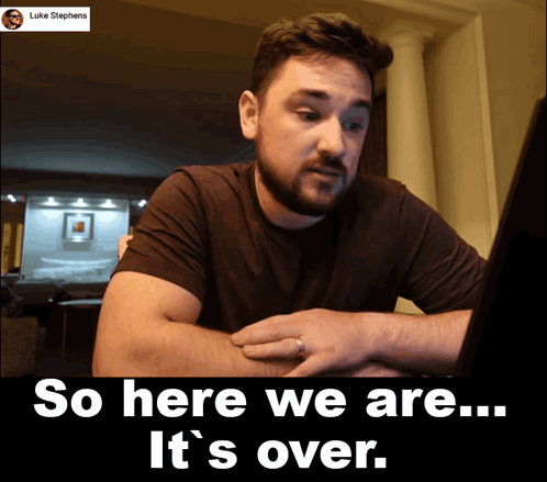 A Man Looking At A Laptop With The Words So Here We Are It 'S Over Below Him GIF