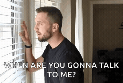 A Man Looking Out A Window With The Words " When Are You Gonna Talk To Me " Above Him GIF