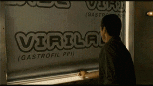 A Man Looking Out Of A Window With The Word Virlog Written On It GIF