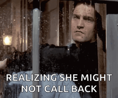 A Man Looking Out Of A Window With The Words Realizing She Might Not Call Back GIF