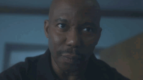 A Man Looks At Another Man 'S Finger Which Is Pointing At His Face GIF