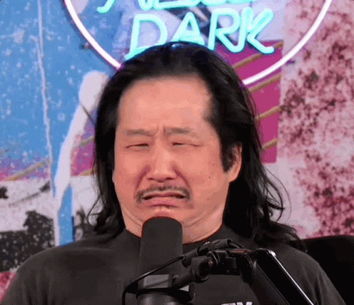 A Man Making A Funny Face In Front Of A Sign That Says Dark GIF