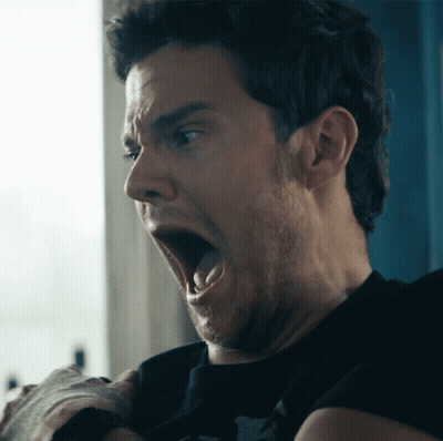 A Man Making A Funny Face With His Mouth Wide Open GIF
