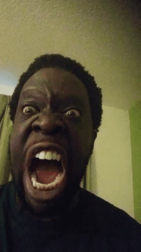 A Man Making A Funny Face With His Mouth Wide Open GIF