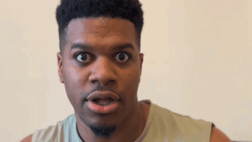 A Man Making A Funny Face With His Mouth Wide Open GIF