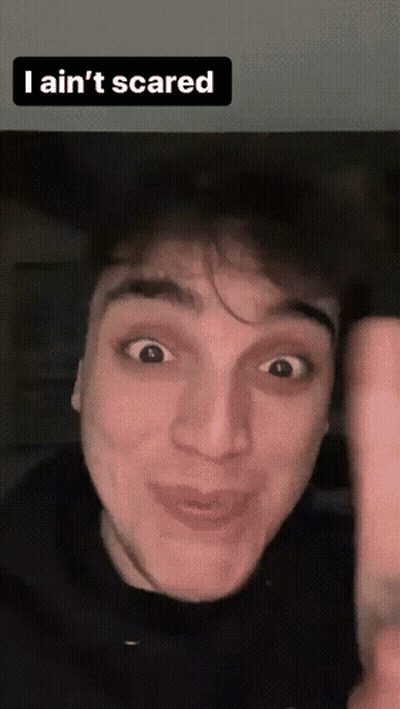 A Man Making A Funny Face With The Words " I Ain 'T Scared " Above Him GIF