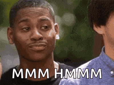 A Man Making A Funny Face With The Words Mmmm Hmmm Written Below Him GIF