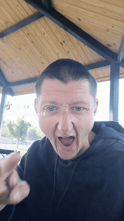 A Man Making A Funny Face With Tik Tok Written On The Bottom Right GIF