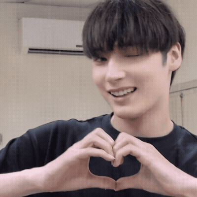 A Man Making A Heart Shape With His Hands GIF