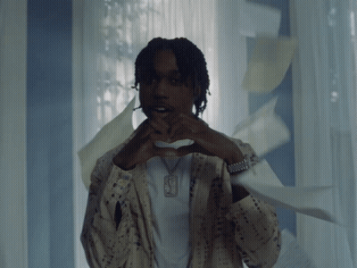 A Man Making A Heart Shape With His Hands And A Necklace With The Letter F On It GIF