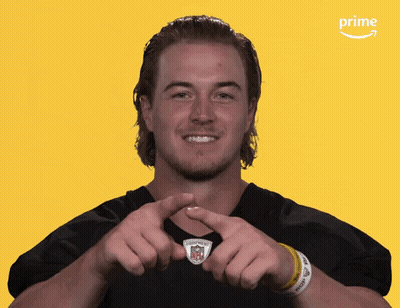 A Man Making A Heart Shape With His Hands In Front Of An Amazon Prime Logo GIF