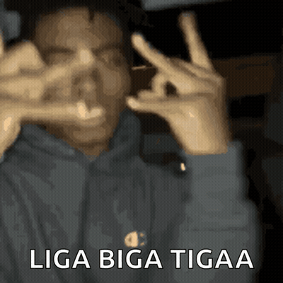 A Man Making A Peace Sign With His Hands And The Words Liga Biga Tigaa GIF