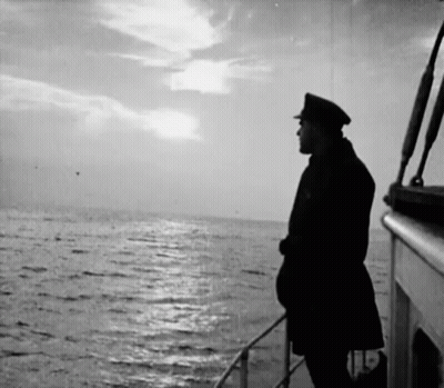 A Man On A Boat Looking Out Over The Ocean GIF
