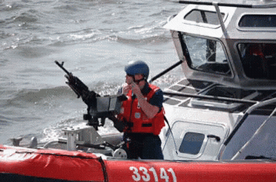 A Man On A Boat With The Number 33143 On The Side Of It GIF