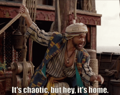 A Man On A Boat With The Words It 'S Chaotic But Hey It 'S Home Below Him GIF