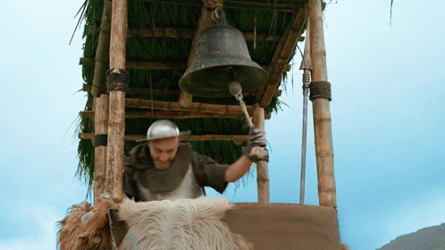 A Man On A Horse Is Ringing A Bell In A Tower GIF