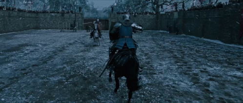 A Man On A Horse With A Shield On His Back GIF