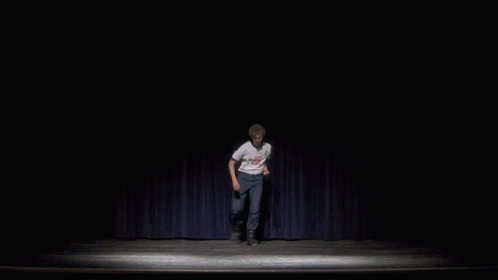 A Man On A Stage Wearing A White Shirt That Says " I Love You " On It GIF