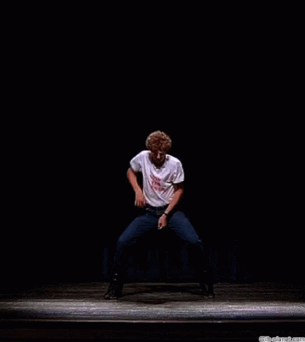 A Man On A Stage Wearing A White Shirt That Says " It 'S A Pa " GIF
