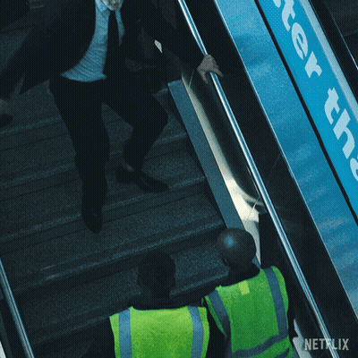 A Man On An Escalator With A Netflix Logo In The Corner GIF