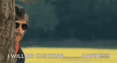 A Man Peeking Out From Behind A Tree Says I Will Be Checking David GIF