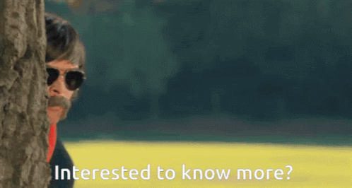 A Man Peeking Out From Behind A Tree With Interested To Know More Written On The Bottom GIF