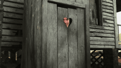 A Man Peeking Out Of A Wooden Door With A Heart Shaped Hole In It GIF