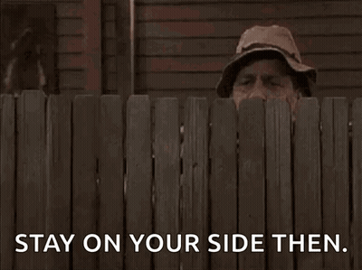 A Man Peeking Over A Wooden Fence With The Words Stay On Your Side Then . GIF
