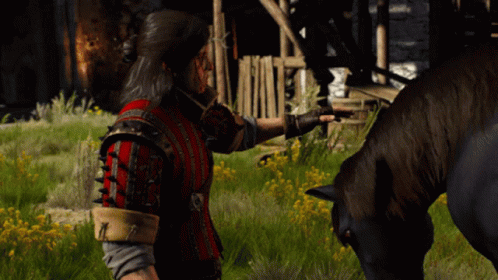 A Man Petting A Horse In A Field With Yellow Flowers GIF