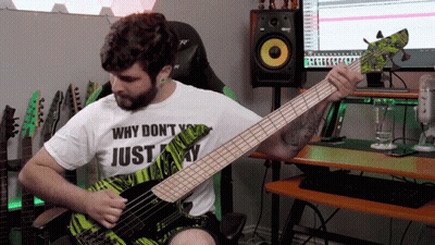 A Man Playing A Bass Guitar With A Shirt That Says Why Don T You Just Play GIF