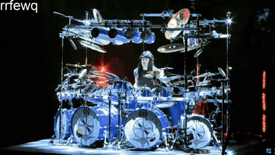 A Man Playing A Drum Set With The Letters Rrfewq On The Bottom Right GIF
