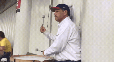 A Man Playing A Drum With A Hat That Says New Era On It GIF