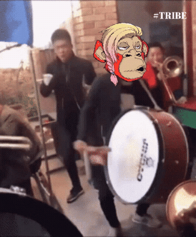A Man Playing A Drum With A Monkey On His Head And The Words #Tribe Below Him GIF