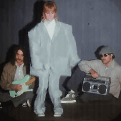 A Man Playing A Guitar And A Man Holding A Boom Box GIF