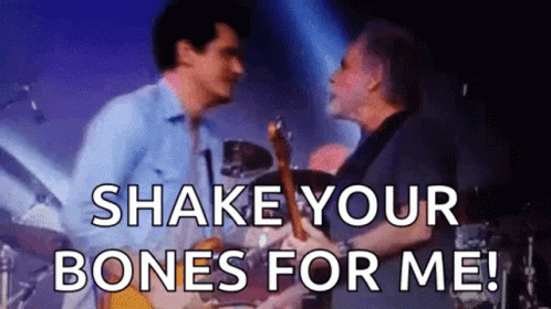A Man Playing A Guitar And A Man Playing Drums On A Stage With The Words Shake Your Bones For Me . GIF