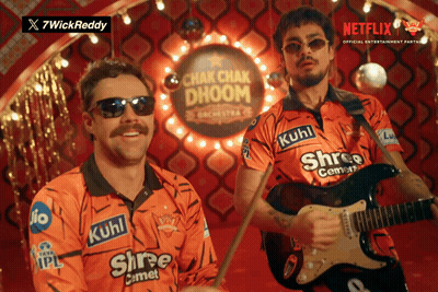 A Man Playing A Guitar And Another Man Playing Drums In Front Of A Sign That Says Chak Chak Dhoom GIF