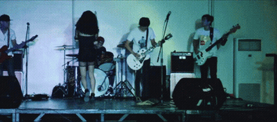 A Man Playing A Guitar Has A Sticker On His Shirt That Says Mcdonalds GIF