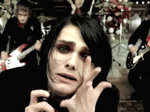 A Man Playing A Guitar In A Band With A Woman Covering Her Eyes GIF